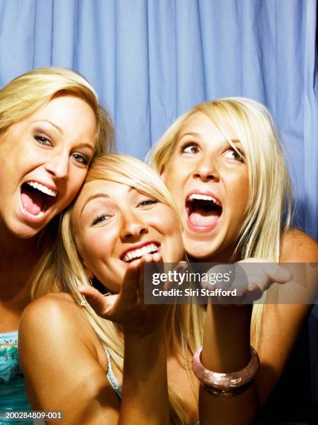 young women having fun in photo booth - open-mouth-kiss stock pictures, royalty-free photos & images