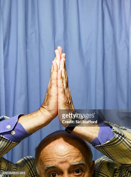 senior man with hands over head in photo booth - completely bald stock photos et images de collection