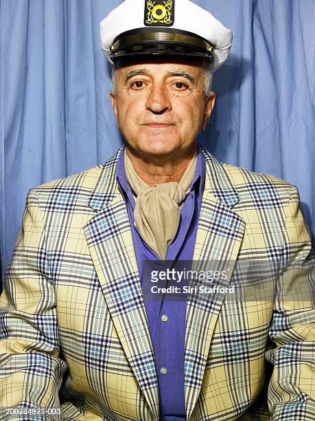senior man wearing blazer and cap in photo booth - cravat fotografías e imágenes de stock