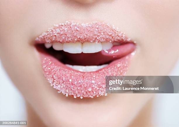 teenage girl (16-18) lips with sugar, close-up - licking lips stock pictures, royalty-free photos & images