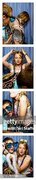 young couple playing around in photo booth - passport sized photograph stock pictures, royalty-free photos & images