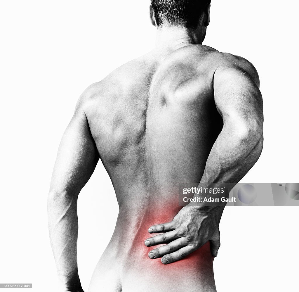 Man with hand to red spot on back, rear view (Digital Enhancement)