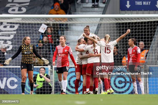 Rachel Williams of Manchester United celebrates with teammates after scoring her team's third goal during the Adobe Women's FA Cup Fifth Round match...