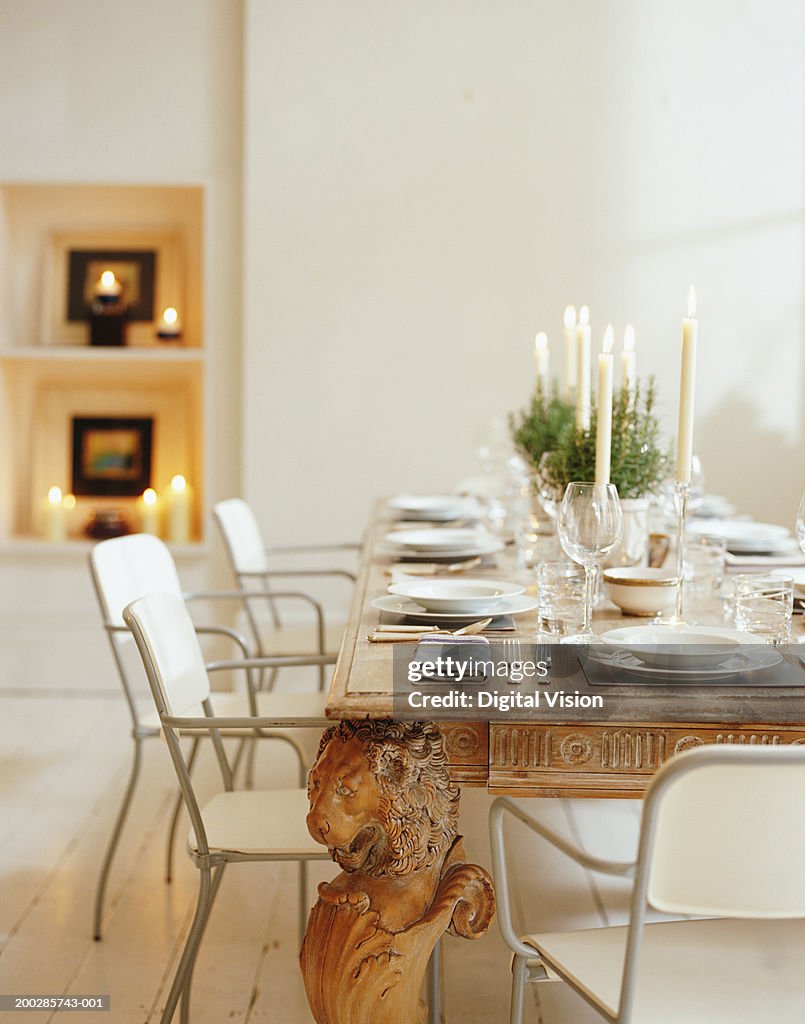 Illuminated candles on table set for table