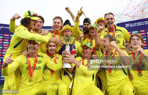 Hugh Weibgen, Captain of Australia, lifts the ICC U19 Men's Cricket World Cup trophy with teammates as they celebrate after defeating India during...