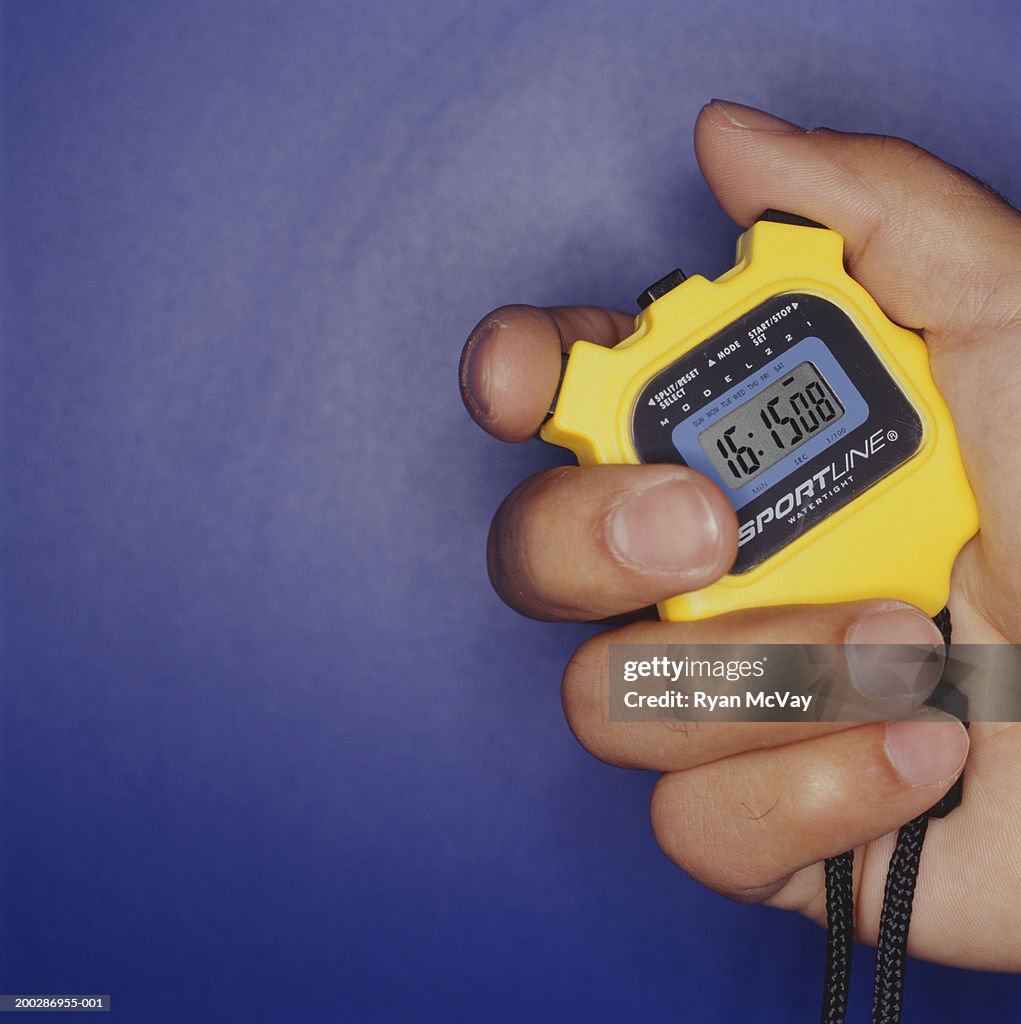 Man holding stopwatch, close up of hand
