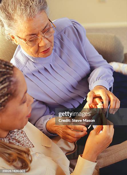 grandmother teaching granddaughter to crochet, elevated view - old granny knitting stock pictures, royalty-free photos & images