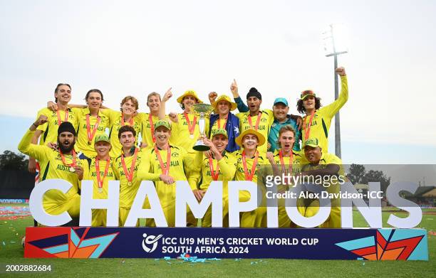 Hugh Weibgen, Captain of Australia, and Harry Dixon lift the ICC U19 Men’s Cricket World Cup trophy as players of Australia pose for a team...