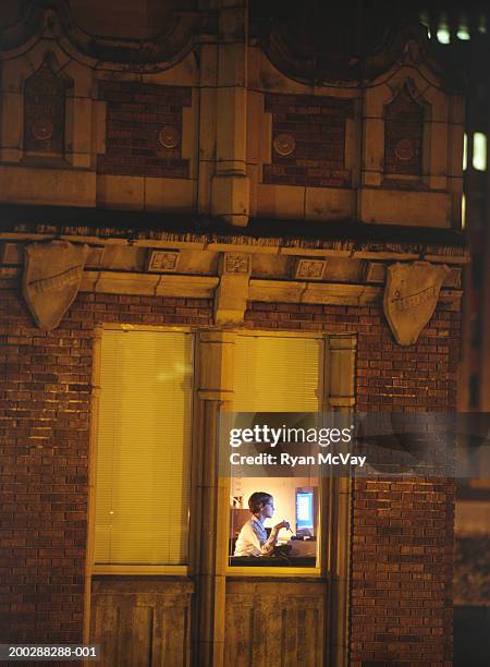 man using computer in flat, elevated view - mann vor pc stock-fotos und bilder