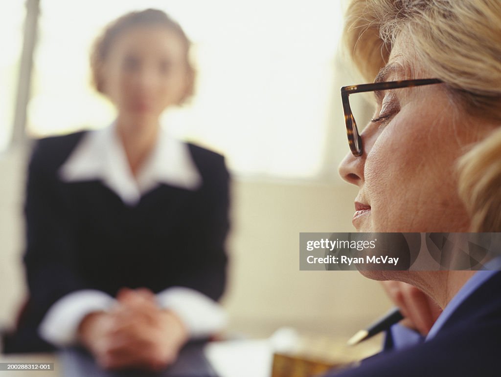 Businesswoman conducting interview, close-up