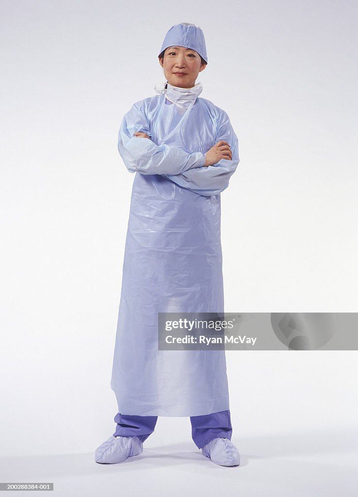 Surgeon wearing surgical gown, posing in studio, portrait