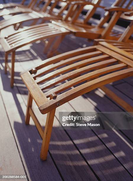 deckchairs standing in line on wooden deck, close-up - spartan cruiser stock pictures, royalty-free photos & images