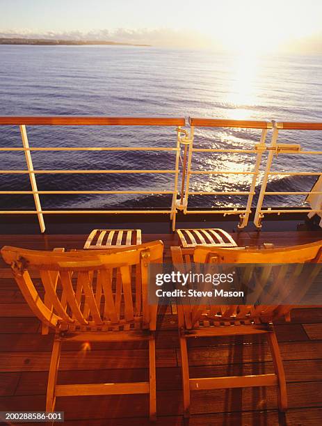 two deckchairs side by side on cruise ship deck - side by side stock pictures, royalty-free photos & images
