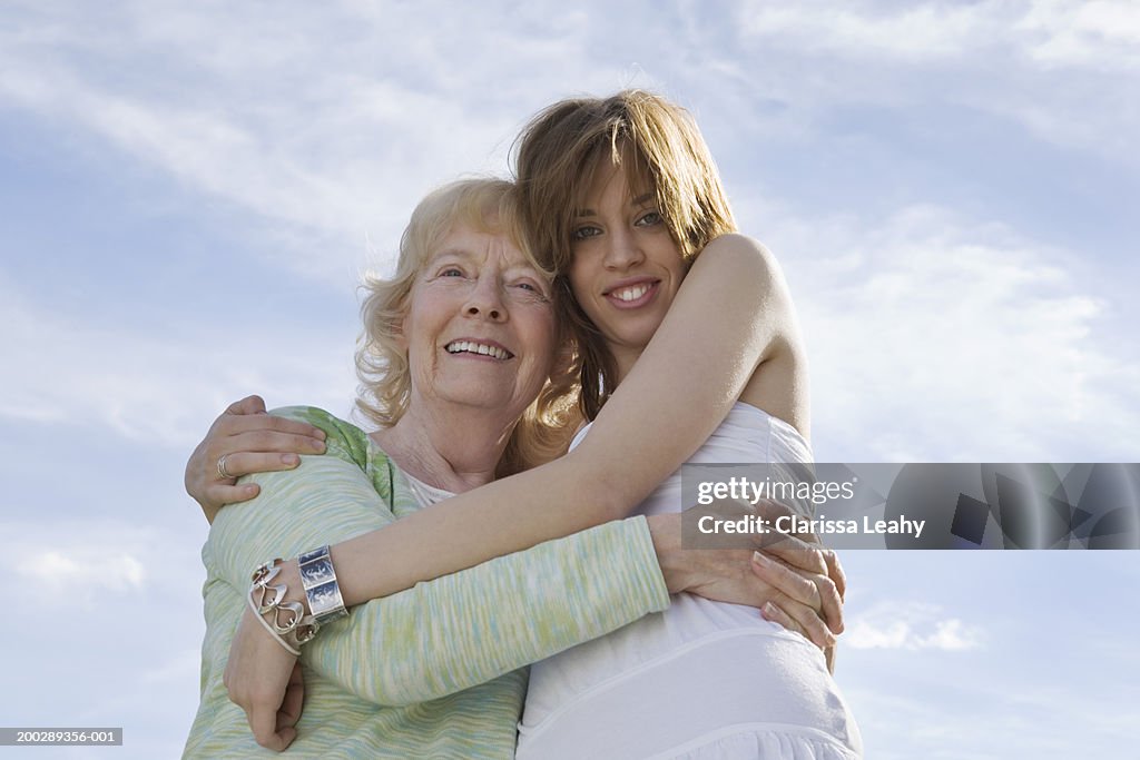 Senior woman and graddaughter embracing, portrait of granddaughter