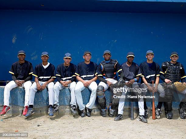 baseball players sitting in dugout, portrait - sports dugout fotografías e imágenes de stock