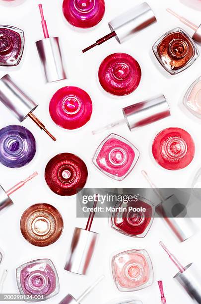 assortment of nail varnish bottles and lids, elevated view - esmalte de uñas fotografías e imágenes de stock