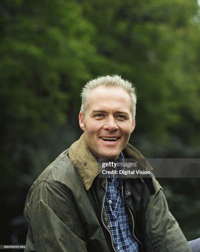 Mature man outdoors, smiling, portrait, close-up