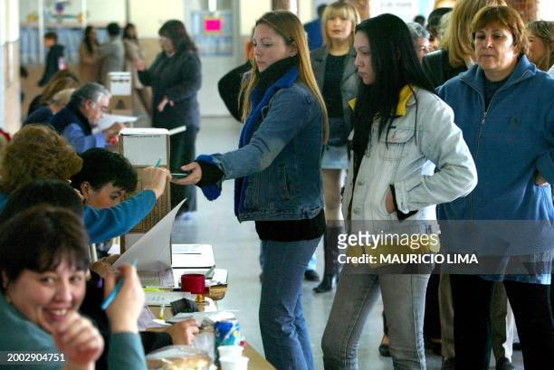 Young Argentinian female voters gets her identification cleared for voting, 27 April in Santa Cruz, some 2800 km from Buenos Aires during the...