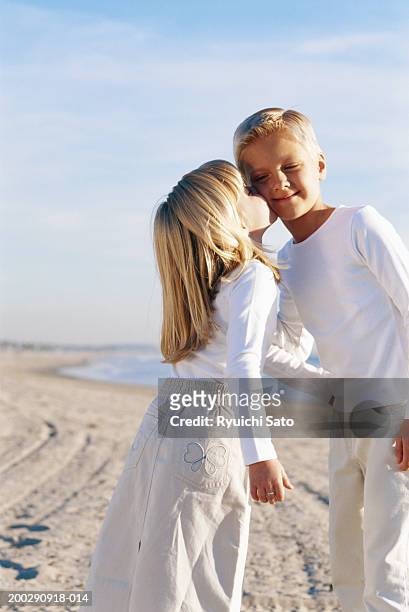 girl kissing boy (4-7), low angle view - boy girl kissing stock pictures, royalty-free photos & images