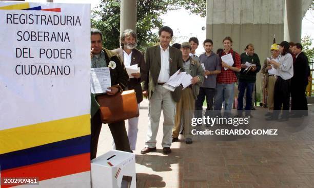 Group of citizenz stand in line during a symbolic vote by Colombians to legalize drugs at the US Embassy 06 November, 2002 in Bogota. AFP...