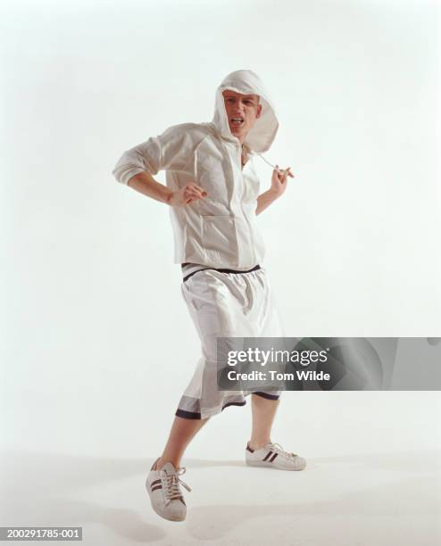 young man wearing hooded top dancing, portrait - falda blanca fotografías e imágenes de stock