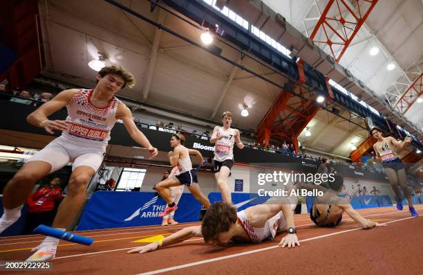 The team from Upper Dublin-PA fumble the baton on the exchange in the Boys' 4x800 race during the 116th Millrose Games at The Armory Track on...