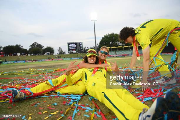 Charlie Anderson of Australia celebrates with Sam Konstas and Tom Straker after defeating India during the ICC U19 Men's Cricket World Cup South...