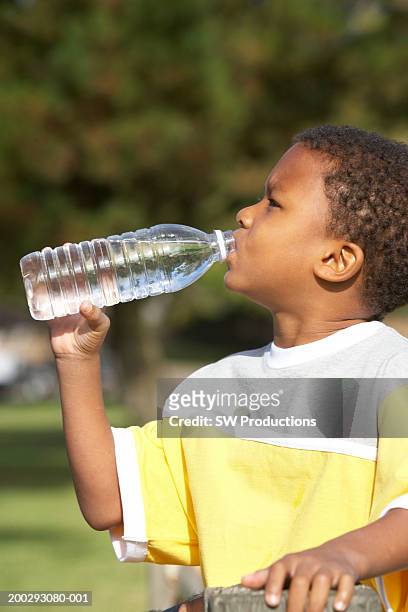 Boy Drinking From Water Bottle Side View High-Res Stock Photo