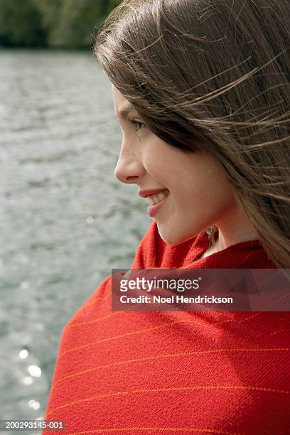 teenage girl (13-15 years) beside lake wearing shawl, smiling, close-up, profile - 14 15 years girl stock pictures, royalty-free photos & images