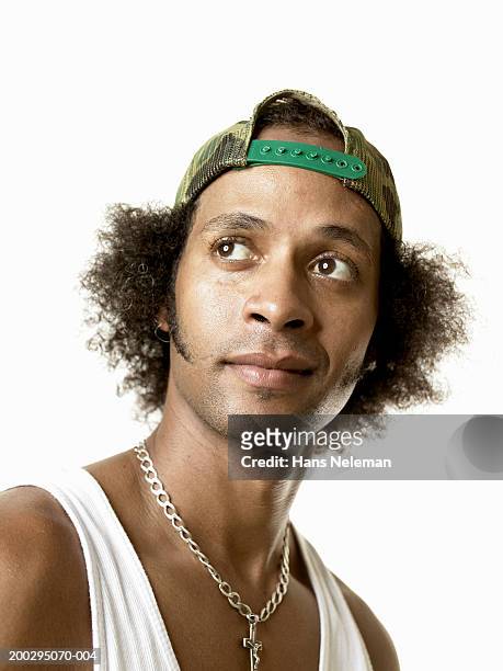 young man wearing cap backward, smiling, close-up - looking backwards stock pictures, royalty-free photos & images