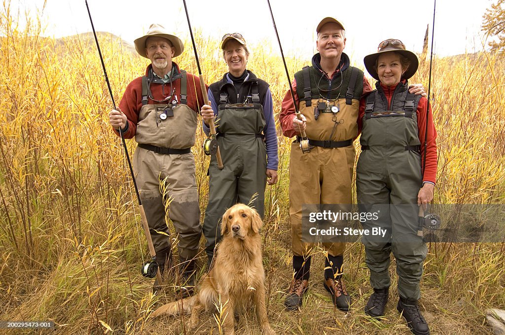 Mature Men And Women With Fly Fishing Gear And Dog Smiling Portrait  High-Res Stock Photo - Getty Images