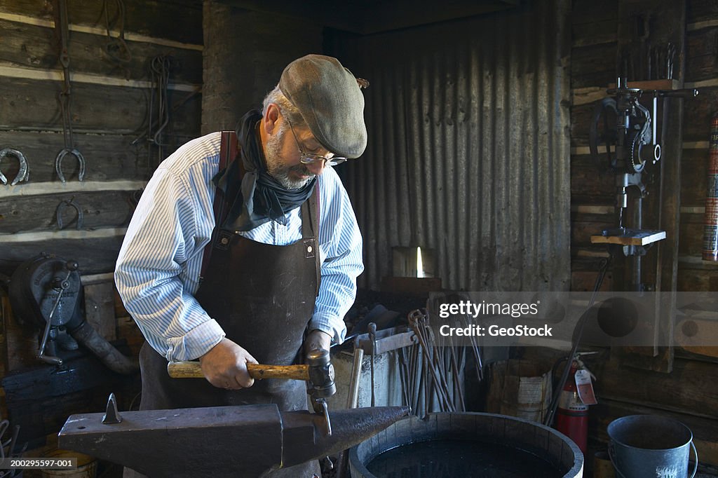 Blacksmith working on horseshoe in shop