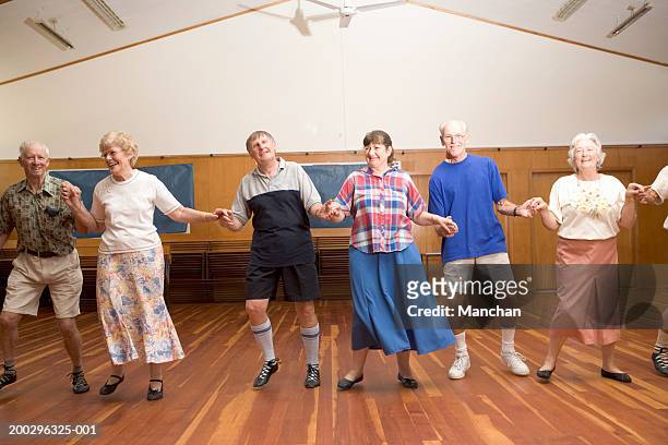 mature couple and senior couples country dancing in hall, portrait - line dancing stock pictures, royalty-free photos & images