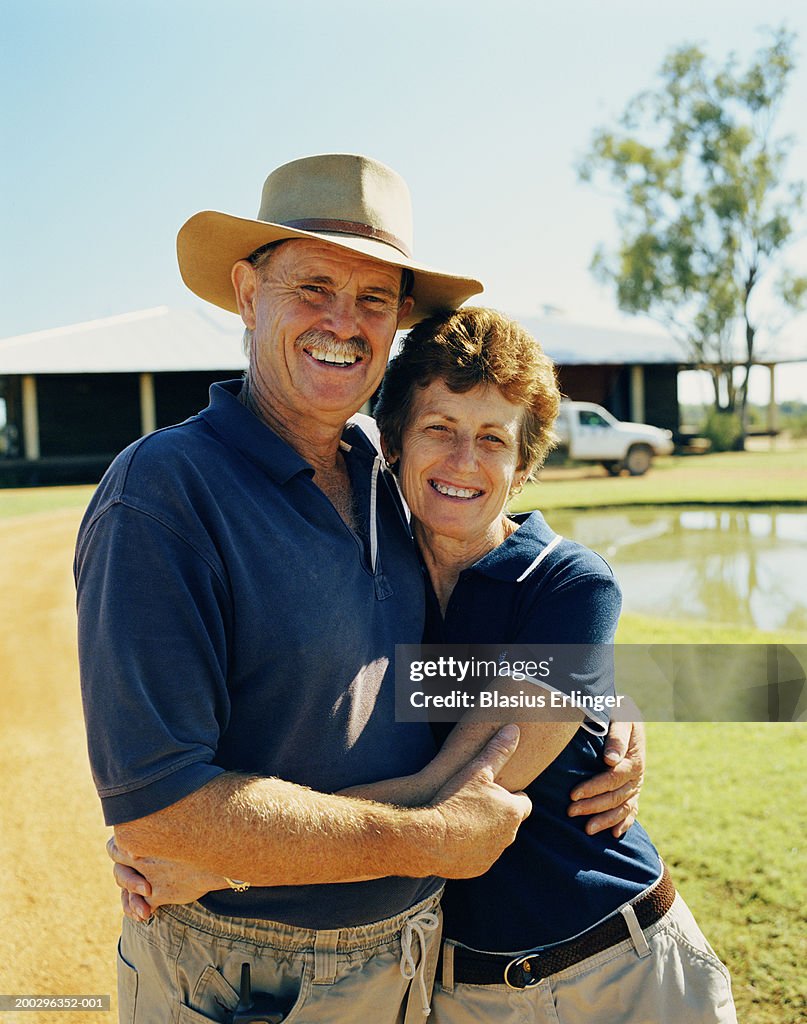 Mature couple embracing at desert lodge, portrait