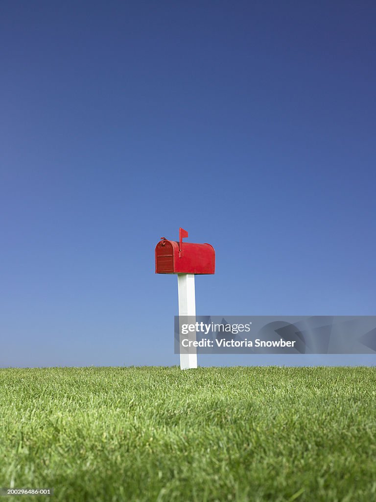 Red mailbox in field