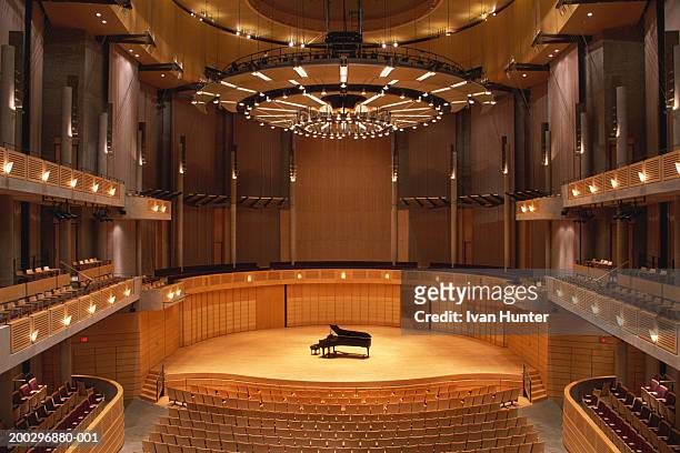 interior of empty theater, piano at center stage, elevated view - assenza foto e immagini stock
