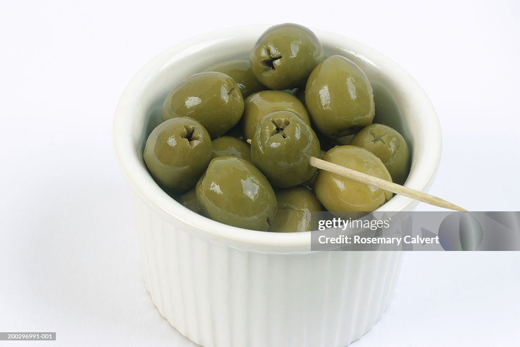 Green olives in dish, close-up