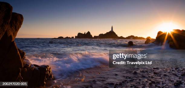 channel islands, jersey, la corbiere lighthouse, sunset - jersey channel islands stock pictures, royalty-free photos & images