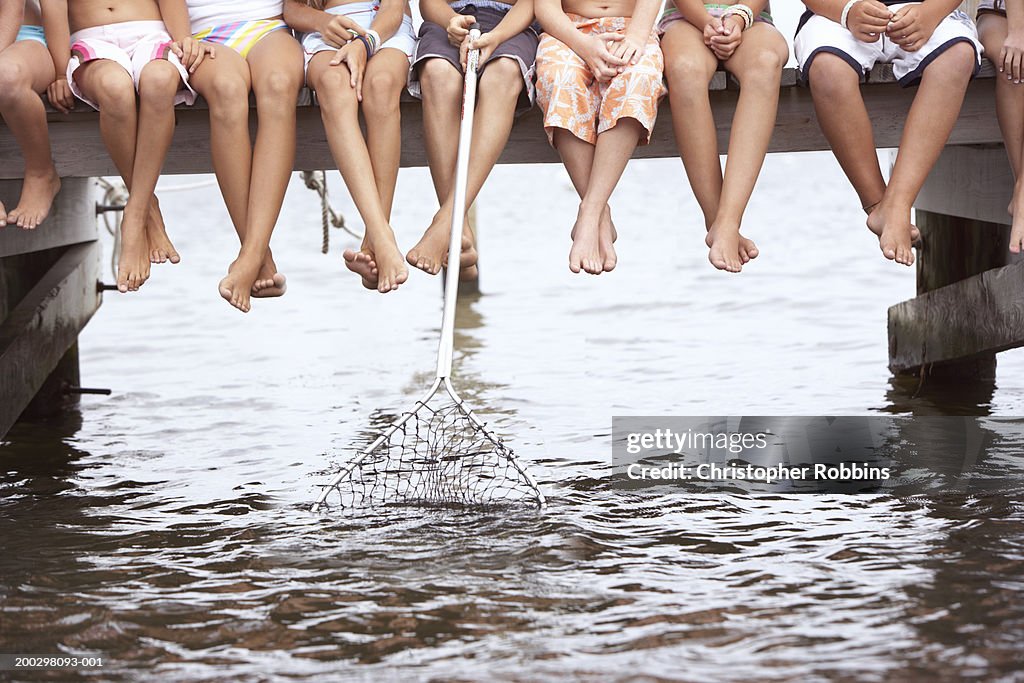 Group of children (6-12) on jetty, low section (Digital Composite)