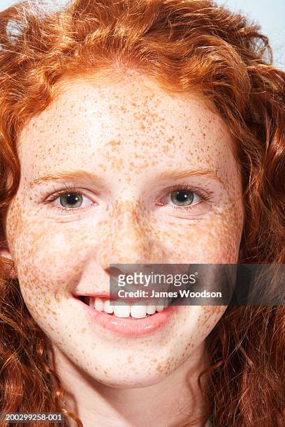 teenage girl (13-15) with curly hair and freckles, smiling, portrait - freckle girl stock pictures, royalty-free photos & images