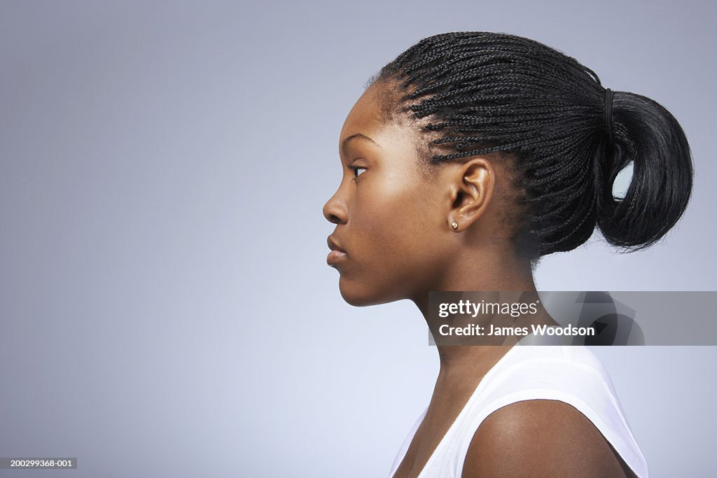 Teenage girl (15-17) with hair tied back, close-up, profile