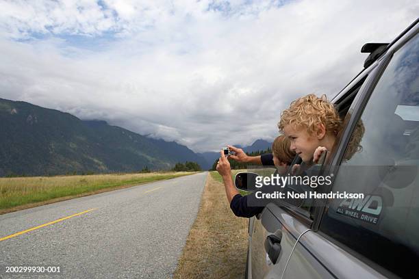 canada, british columbia, man photographing scenery from car window - open day 7 stock pictures, royalty-free photos & images