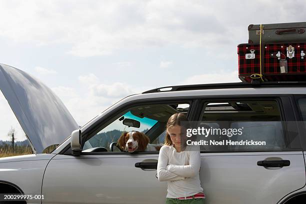 girl (6-8 years), portrait, standing beside car with bonnet open - inconvenience stock pictures, royalty-free photos & images