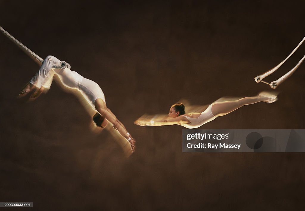 Trapeze artist's, woman stretching for man's hands (Digital Composite)