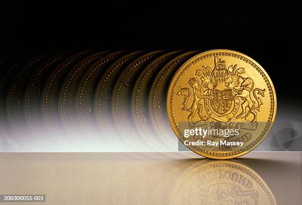 british currency: one pound coin, rolling (multiple exposure) - one pound coin stock pictures, royalty-free photos & images