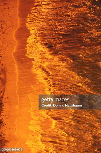 bahamas, waves crashing onto cable beach, elevated view, sunset - cable beach bahamas stock pictures, royalty-free photos & images