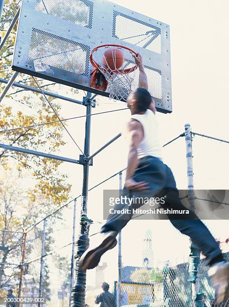 man playing basketball, low angle view (blurred motion) - running mate fotografías e imágenes de stock