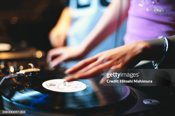 female disc jockey spinning records, mid section - vinyl records stock-fotos und bilder