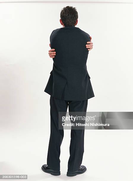 businessman standing, rear view - faze rug stockfoto's en -beelden