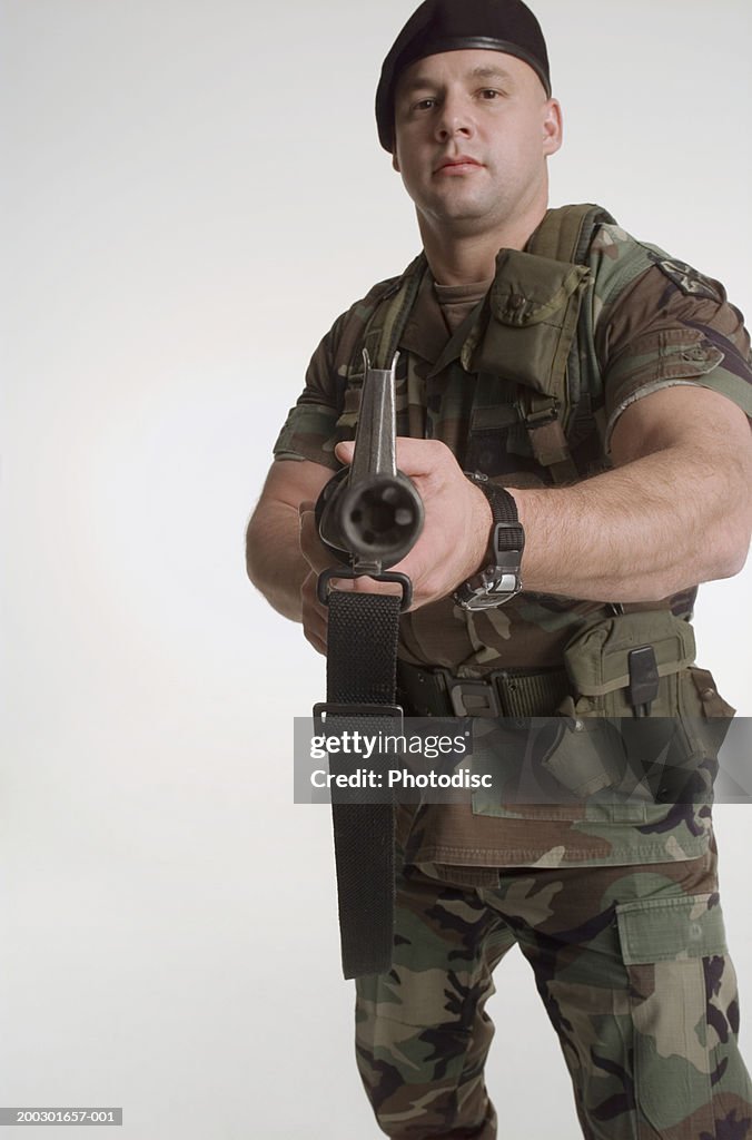 Soldier holding grenade launcher, portrait